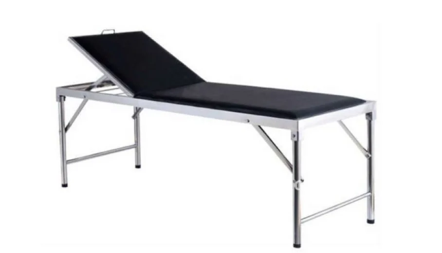 Examination couch with black upholstery, a raised back section and a silver-coloured frame